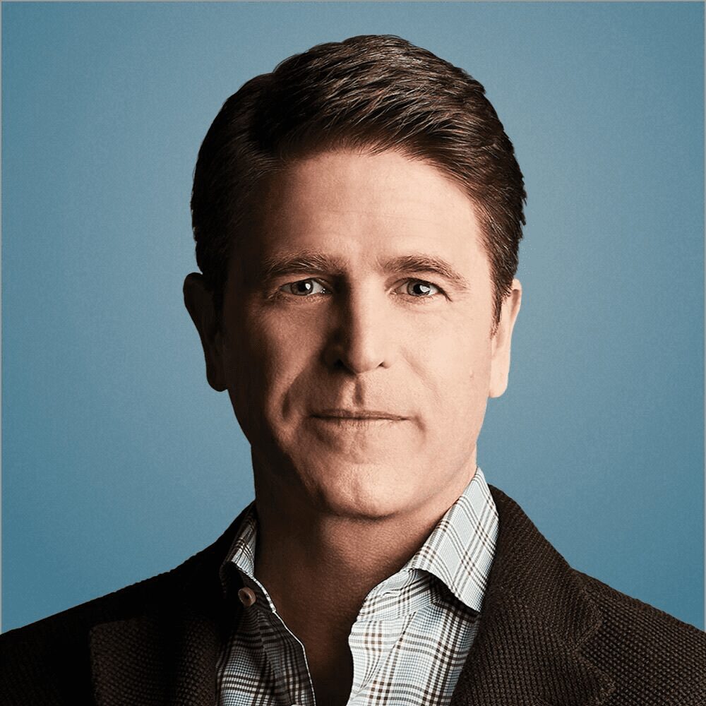 Man in suit against blue background.